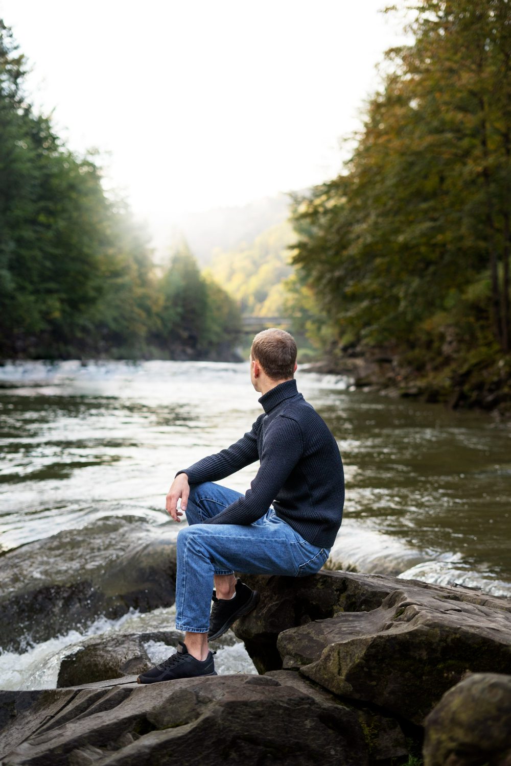 side-view-man-sitting-by-river